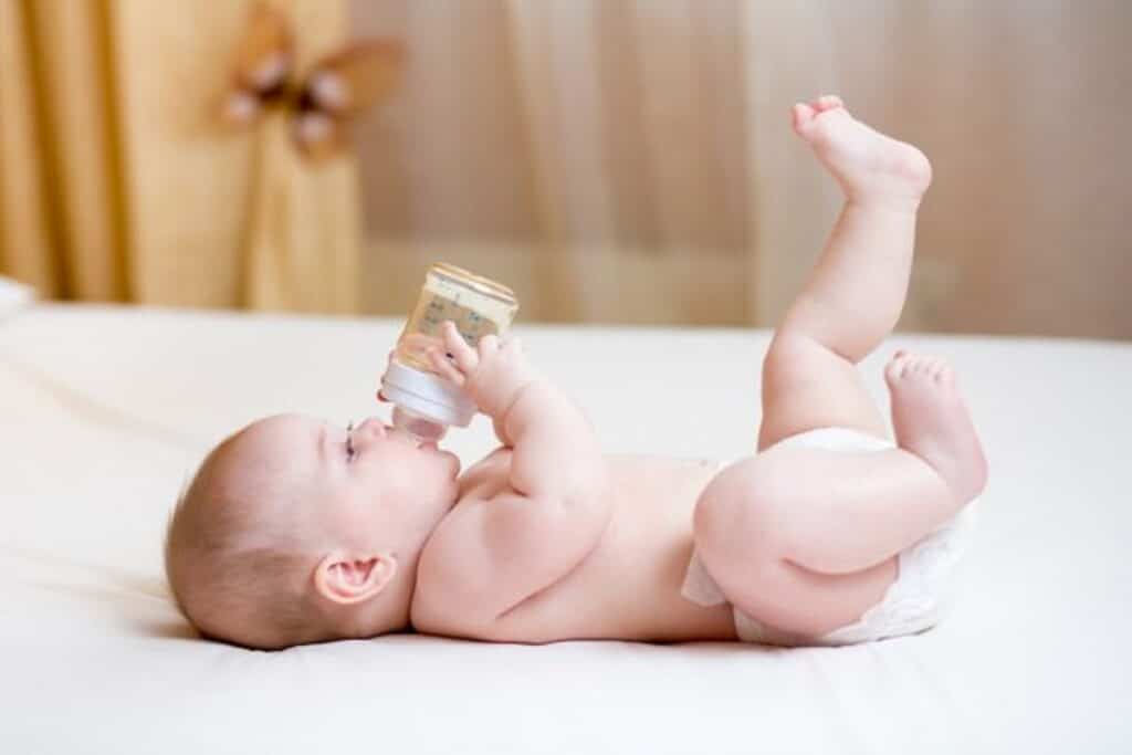 depositphotos 55039631 stock photo baby drinking water from bottle