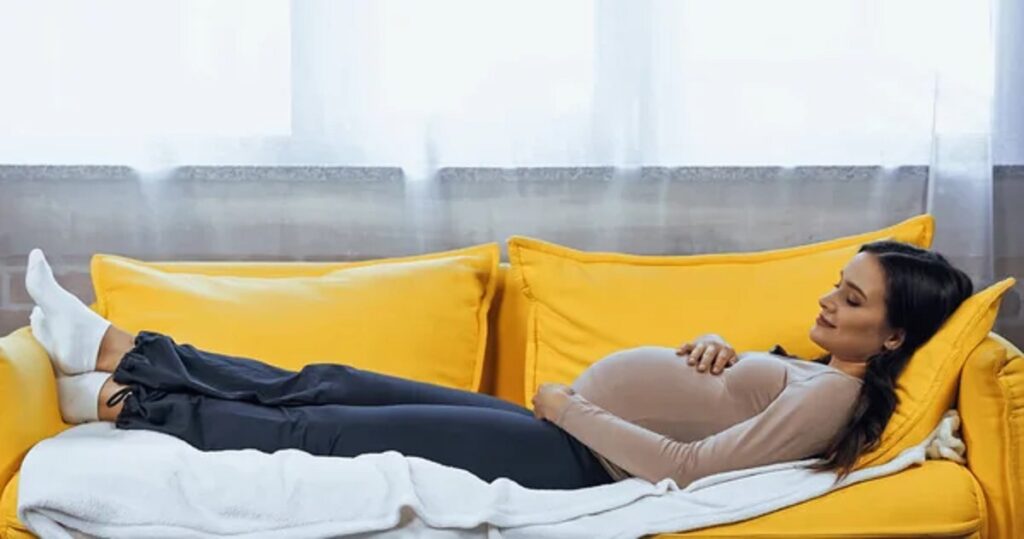 depositphotos 452600194 stock photo pregnant woman relaxing sofa home