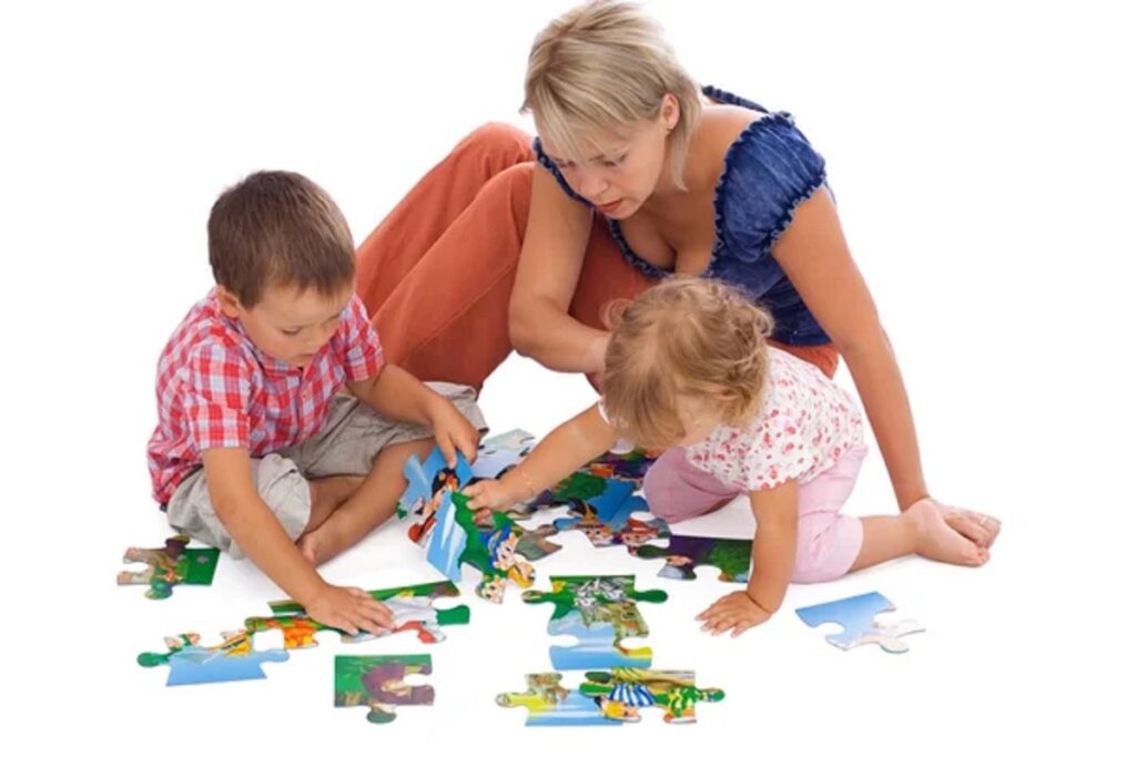 depositphotos 6441366 stock photo family playing with puzzle